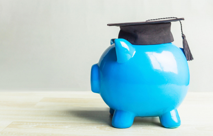 blue piggy bank wearing graduation cap